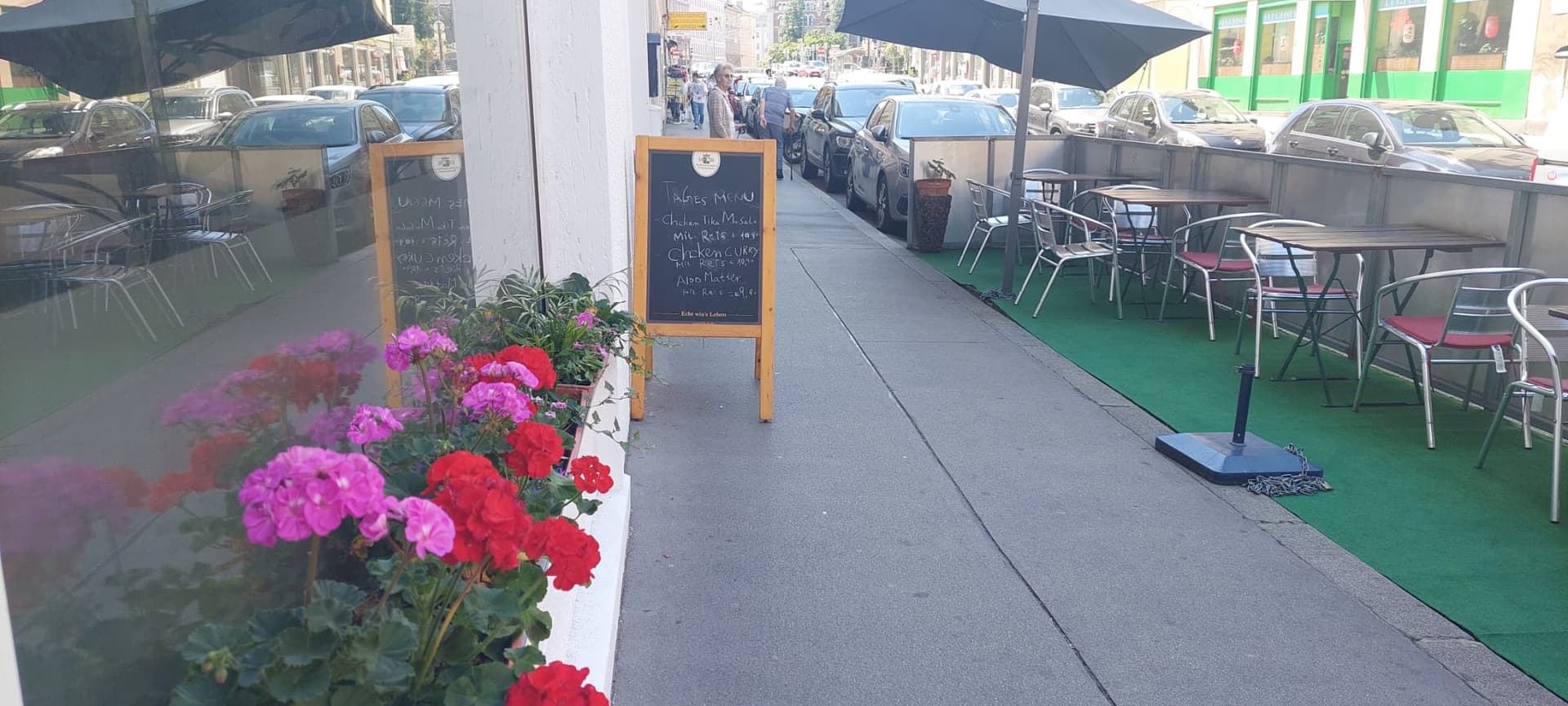 Outside of restaurant with tables with umbrella 